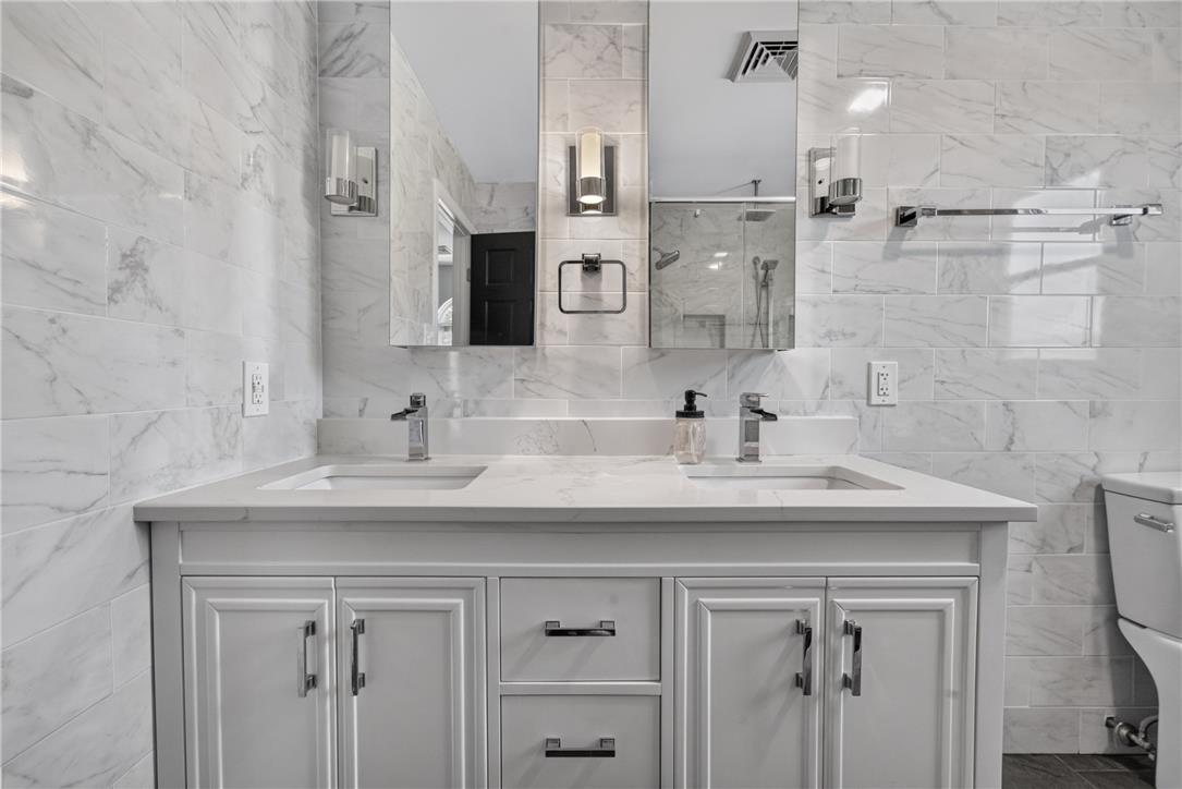 220 Pennbrook Road Stroudsburg, PA 18360 - Photo 29 of 60 Dual vanity with sleek fixtures offers a sophisticated retreat.