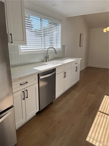 a kitchen with sink and large window