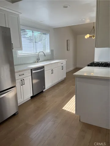 a kitchen with white cabinets and white appliances