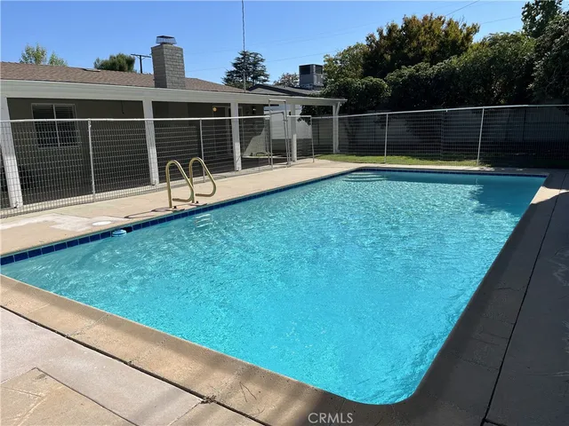 a view of a backyard with a wooden bench
