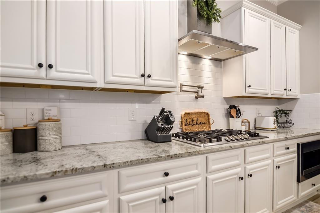 601 Legacy Run Ball Ground, GA 30107 - Photo 15 of 58 a kitchen with stainless steel appliances granite countertop a sink a stove and cabinets