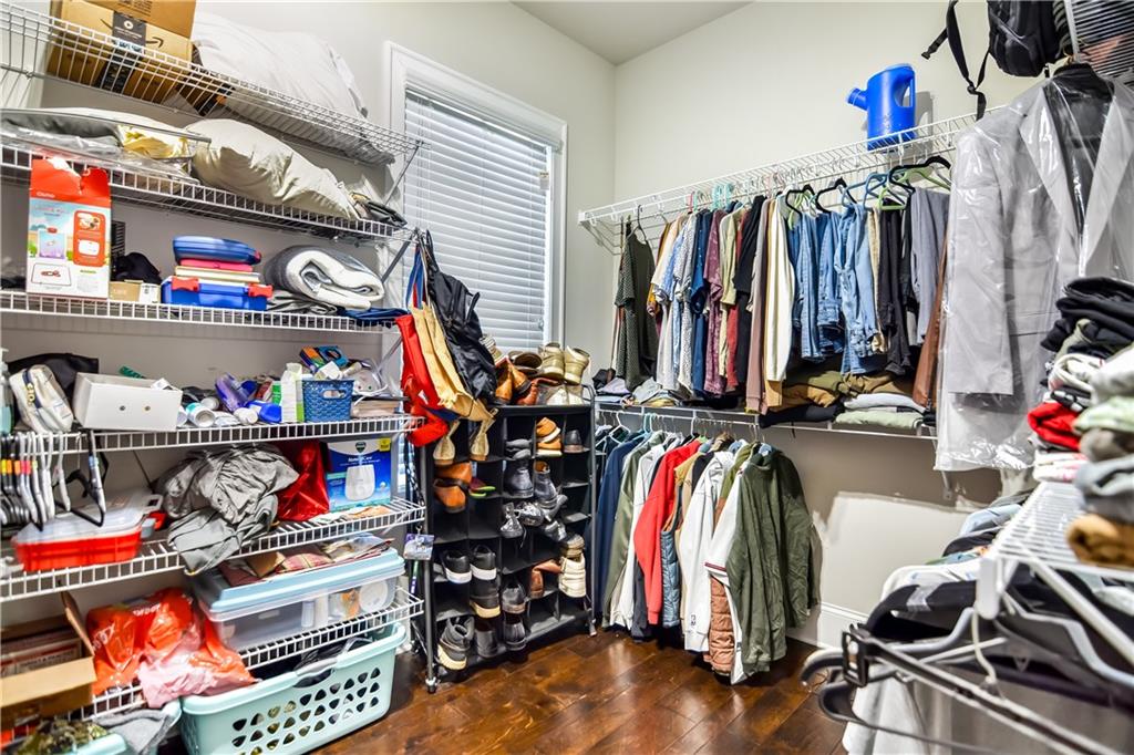 601 Legacy Run Ball Ground, GA 30107 - Photo 27 of 58 a view of walk in closet with clothes and shoes
