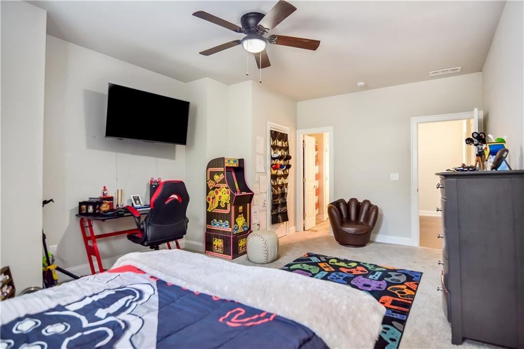 601 Legacy Run Ball Ground, GA 30107 - Photo 40 of 58 a bedroom with a bed and a flat screen tv