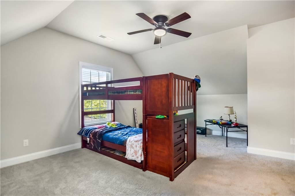 601 Legacy Run Ball Ground, GA 30107 - Photo 44 of 58 a bedroom with a bed and a chandelier
