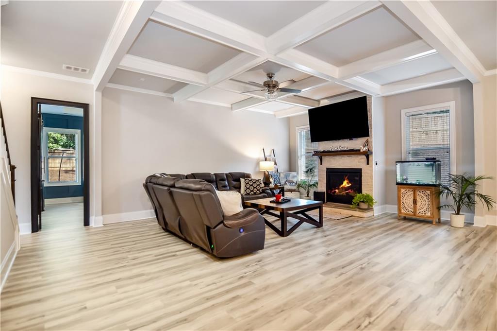 601 Legacy Run Ball Ground, GA 30107 - Photo 8 of 58 a living room with furniture a fireplace a flat screen tv and kitchen view