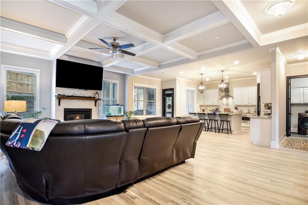 601 Legacy Run Ball Ground, GA 30107 - Photo 10 of 58 a living room with furniture a flat screen tv and a fireplace