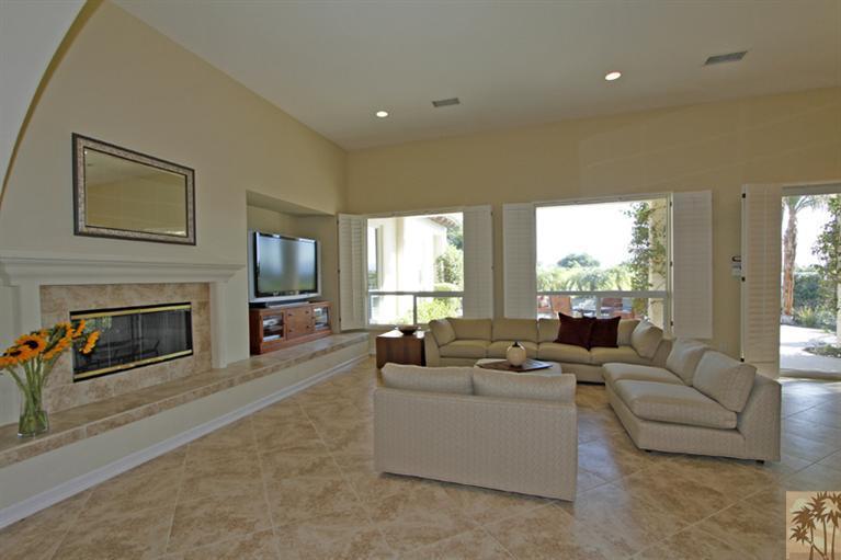 352 Loch Lomond Road Rancho Mirage, CA 92270 - Photo 6 of 25 a living room with furniture a fireplace and a large window