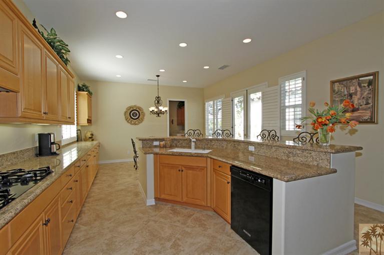 352 Loch Lomond Road Rancho Mirage, CA 92270 - Photo 10 of 25 a kitchen with lots of counter top space sink and stainless steel appliances