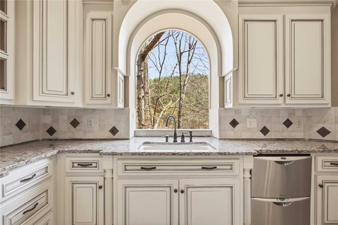 610 Highridge Drive Seneca, SC 29672 - Photo 18 of 50 This spacious kitchen features an arched window and ample cabinetry, offering both charm and practicality.