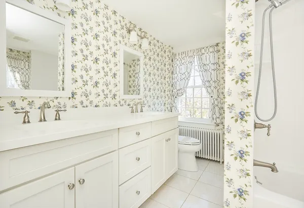 a bathroom with a double vanity sink toilet and shower