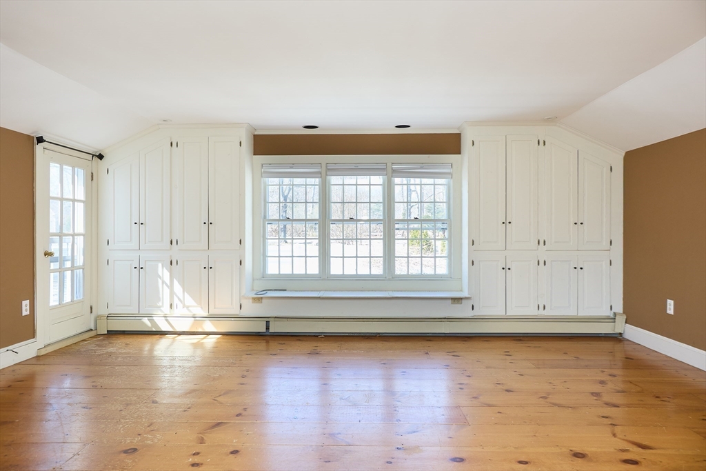 685 Highland Street Marshfield, MA 02050 - Photo 24 of 38 an empty room with wooden floor and windows
