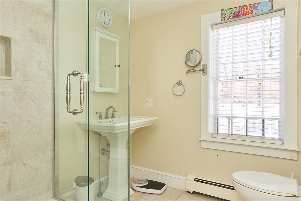 685 Highland Street Marshfield, MA 02050 - Photo 25 of 38 a bathroom with a granite countertop sink a toilet and shower