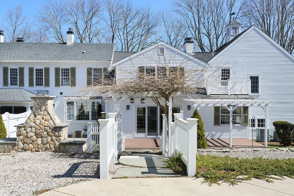 685 Highland Street Marshfield, MA 02050 - Photo 4 of 38 a front view of a house with garden