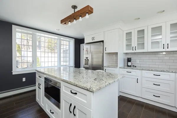 a kitchen with granite countertop cabinets stainless steel appliances and a sink