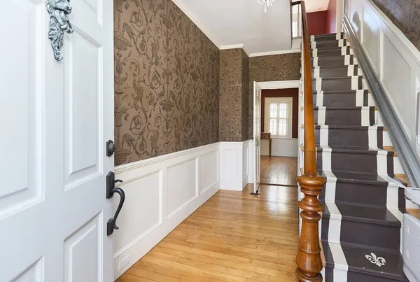 a view of an entryway with wooden floor