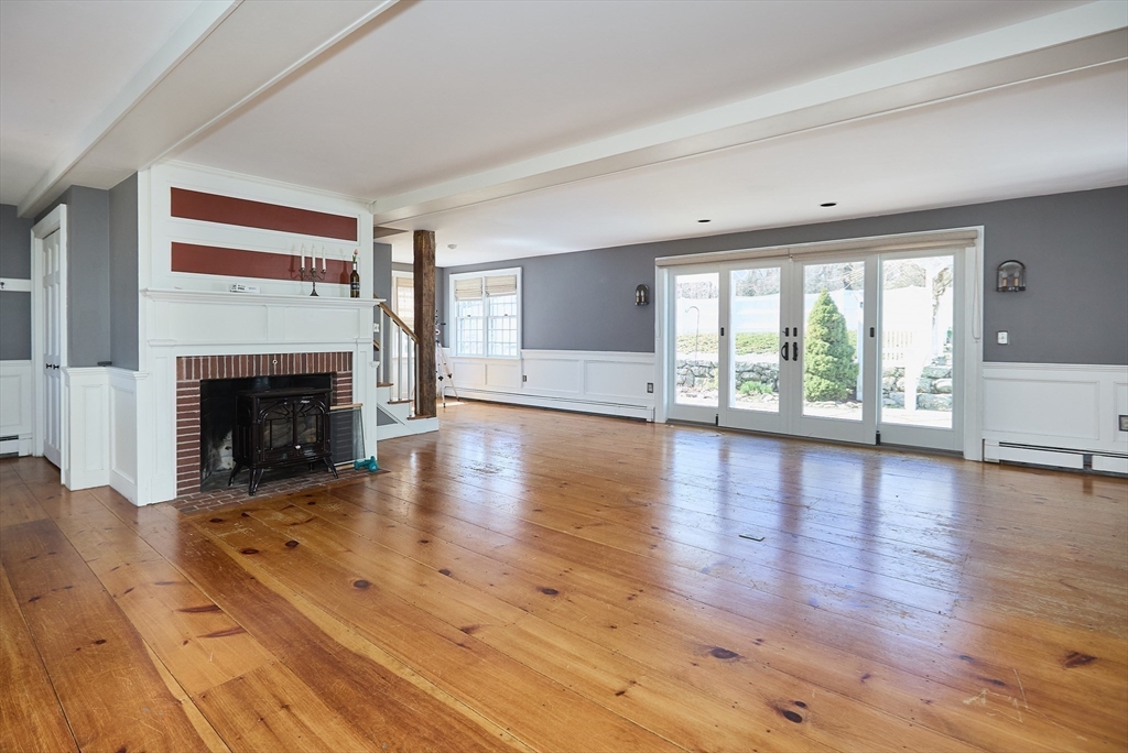 685 Highland Street Marshfield, MA 02050 - Photo 9 of 38 a view of an empty room with wooden floor and a window