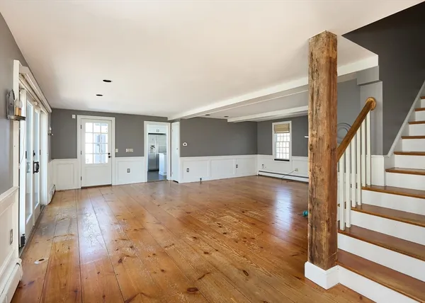 a view of empty room with wooden floor