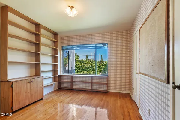 a view of room with window and wooden floor