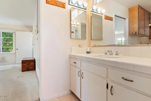 a bathroom with a sink double vanity and a mirror
