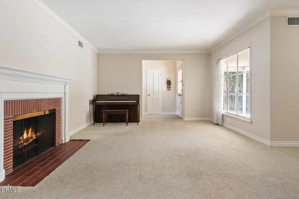 a view of a livingroom with a fireplace and a window