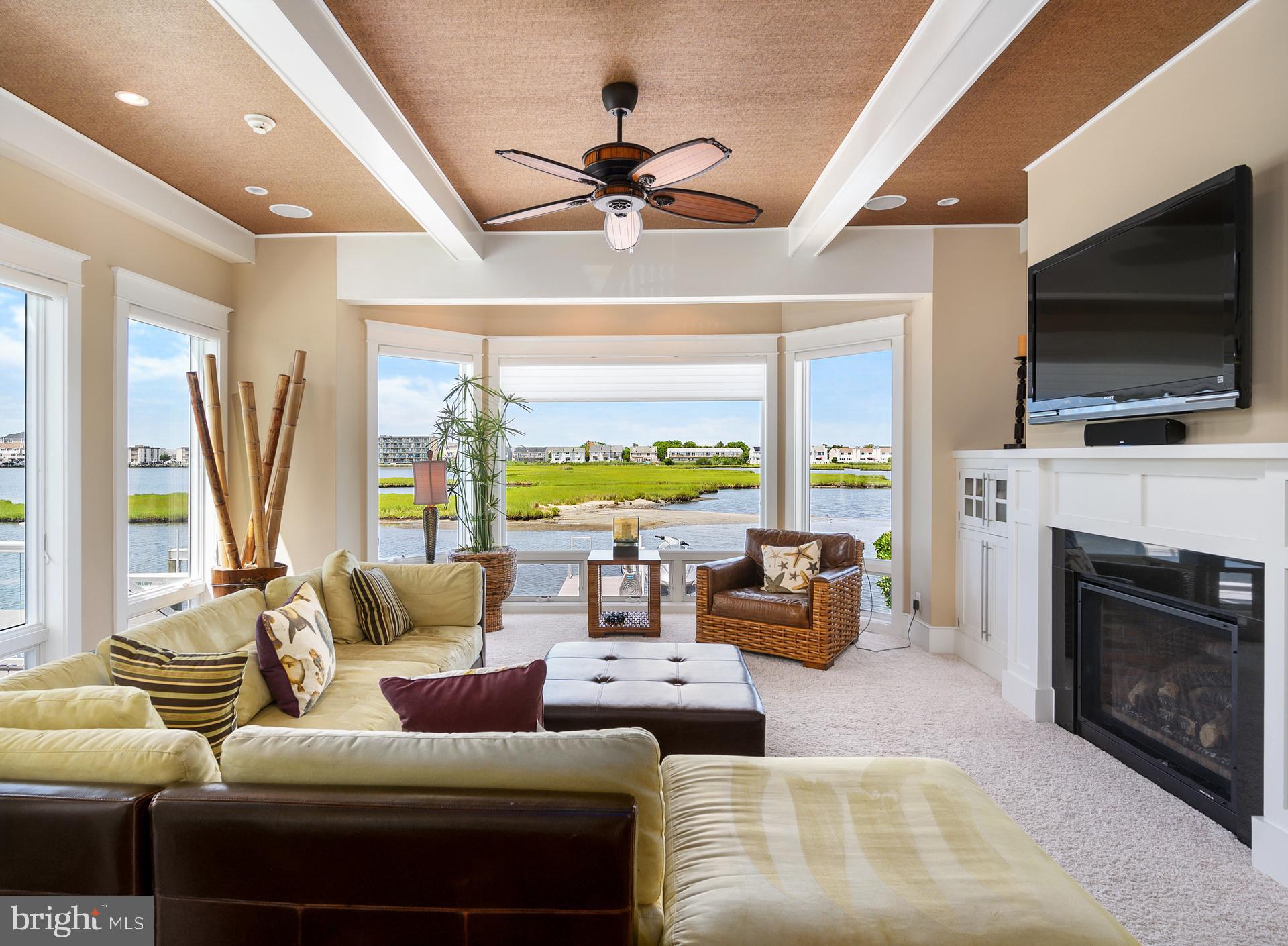 160 Channel Buoy Road Ocean City, MD 21842 - Photo 13 of 71 a living room with fireplace furniture and a flat screen tv