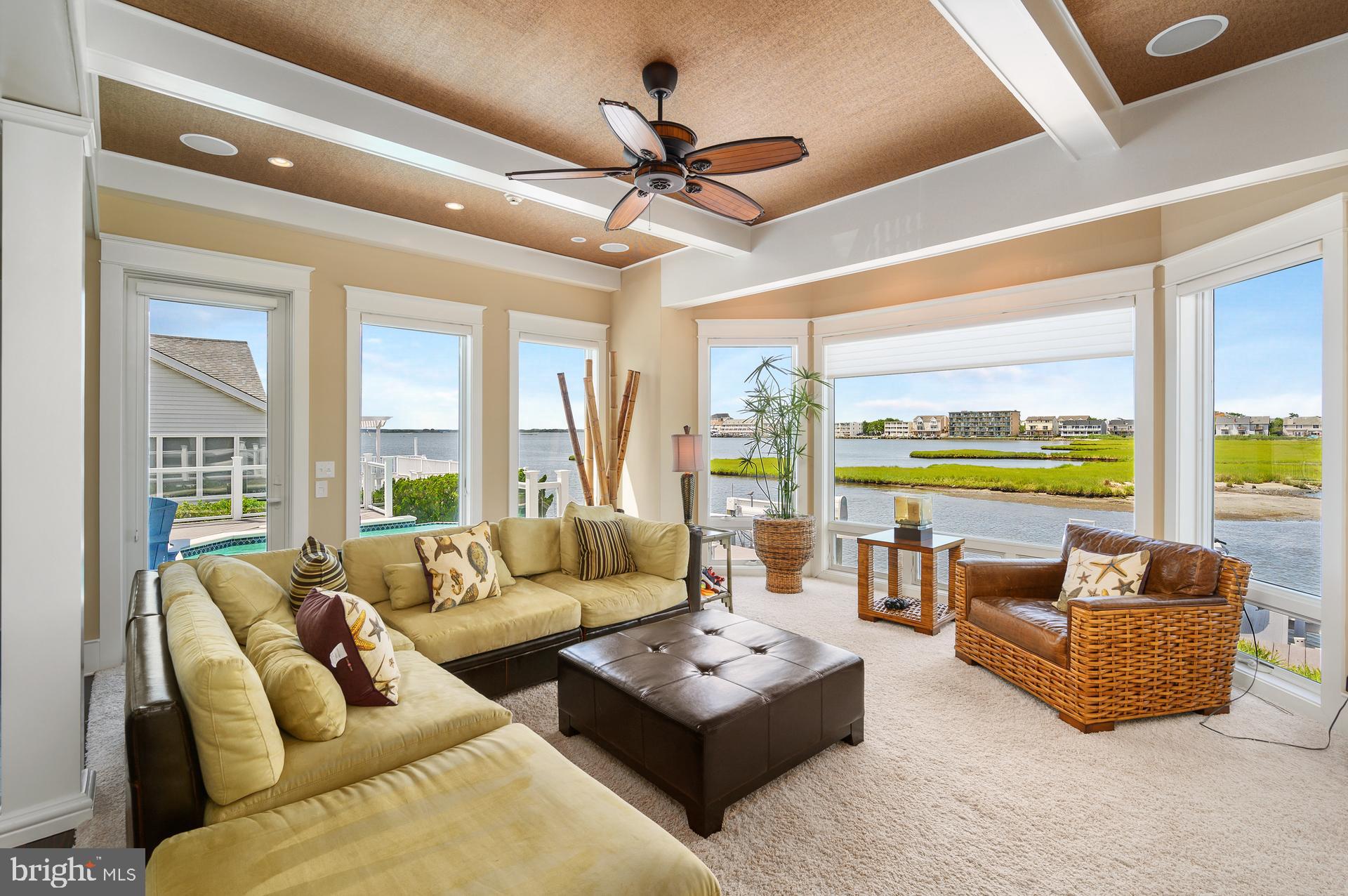 160 Channel Buoy Road Ocean City, MD 21842 - Photo 14 of 71 a living room with furniture and a large window