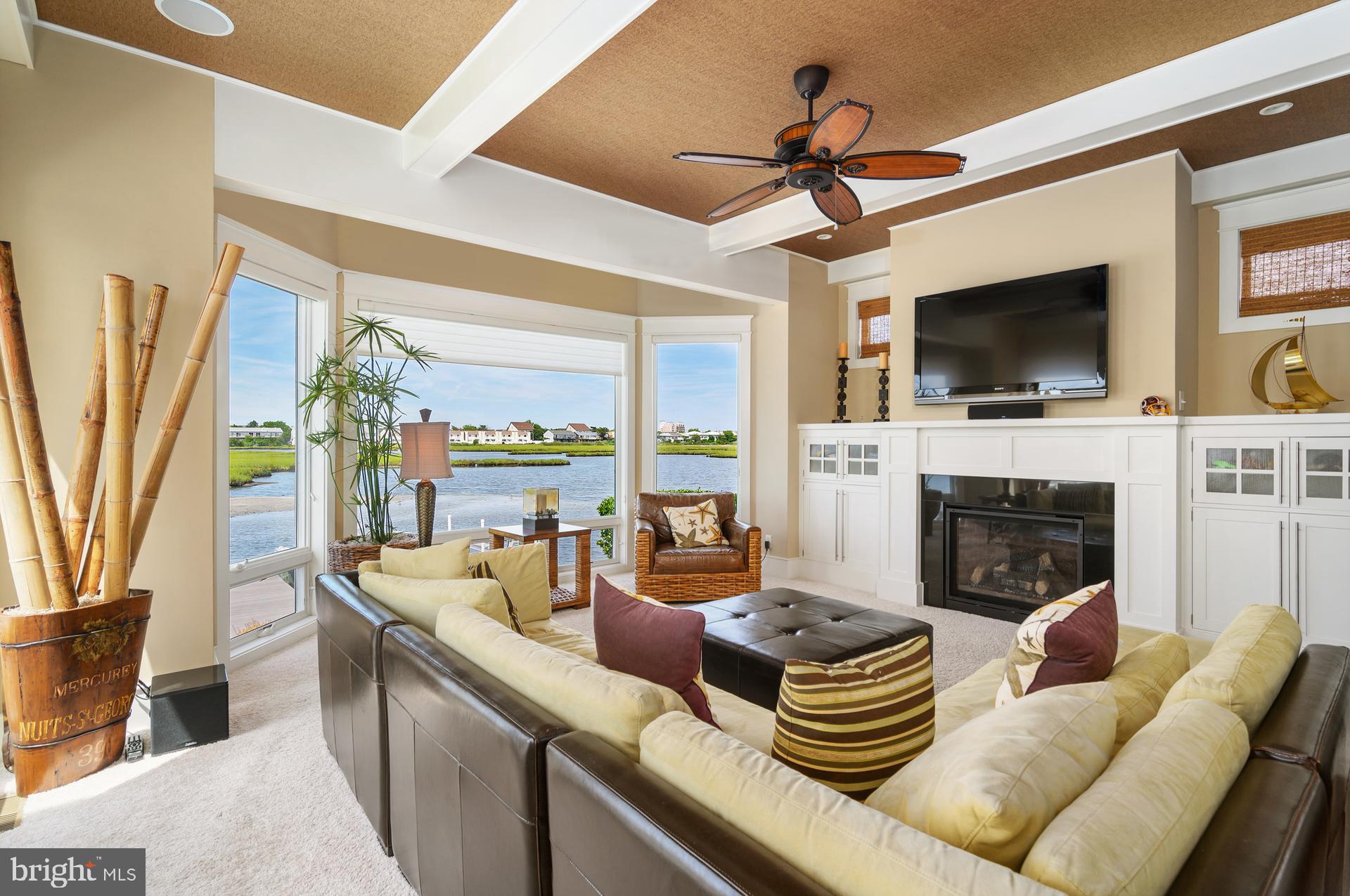 160 Channel Buoy Road Ocean City, MD 21842 - Photo 16 of 71 a living room with fireplace furniture and a flat screen tv