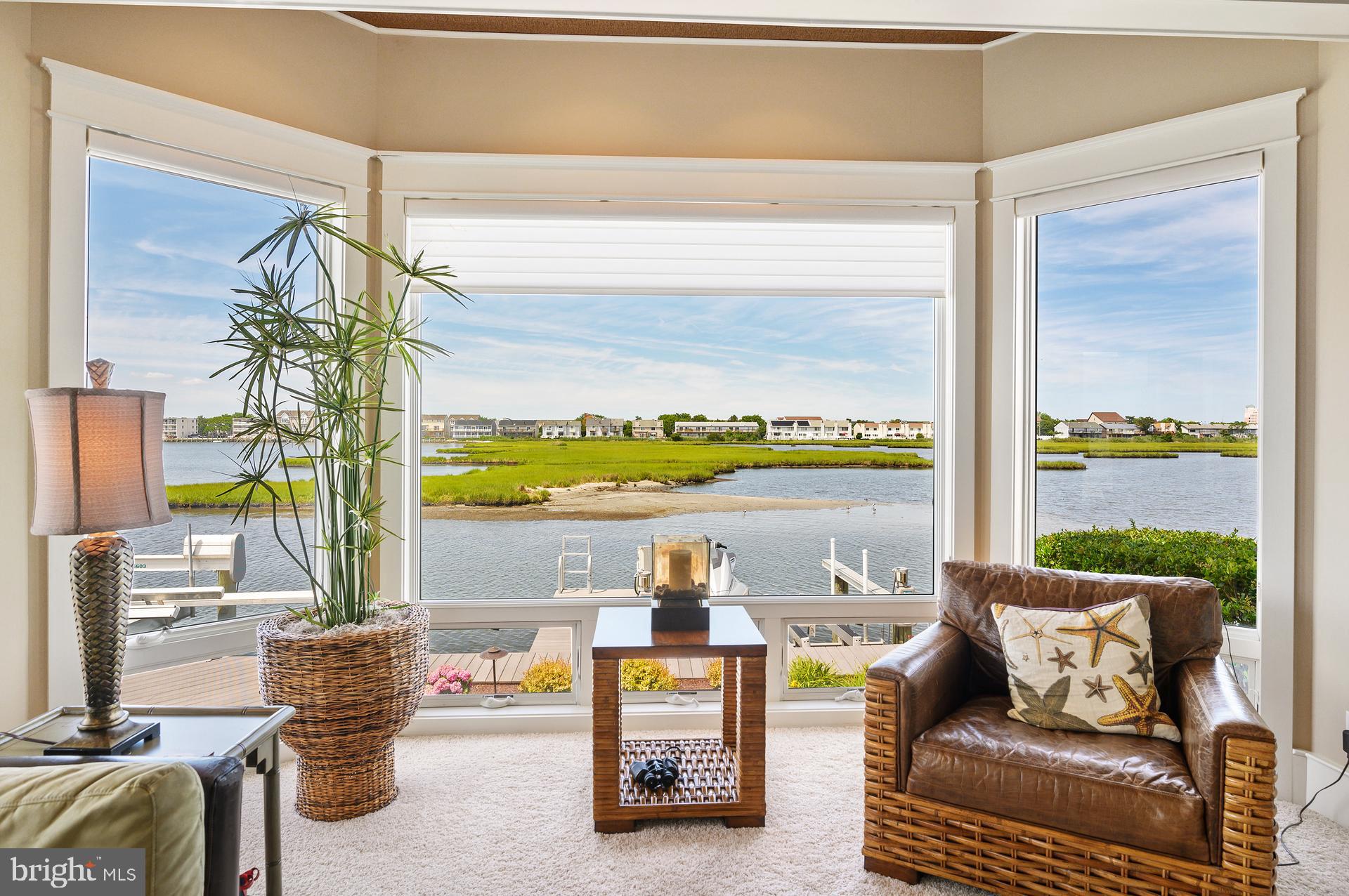 160 Channel Buoy Road Ocean City, MD 21842 - Photo 17 of 71 a living room with furniture and a floor to ceiling window
