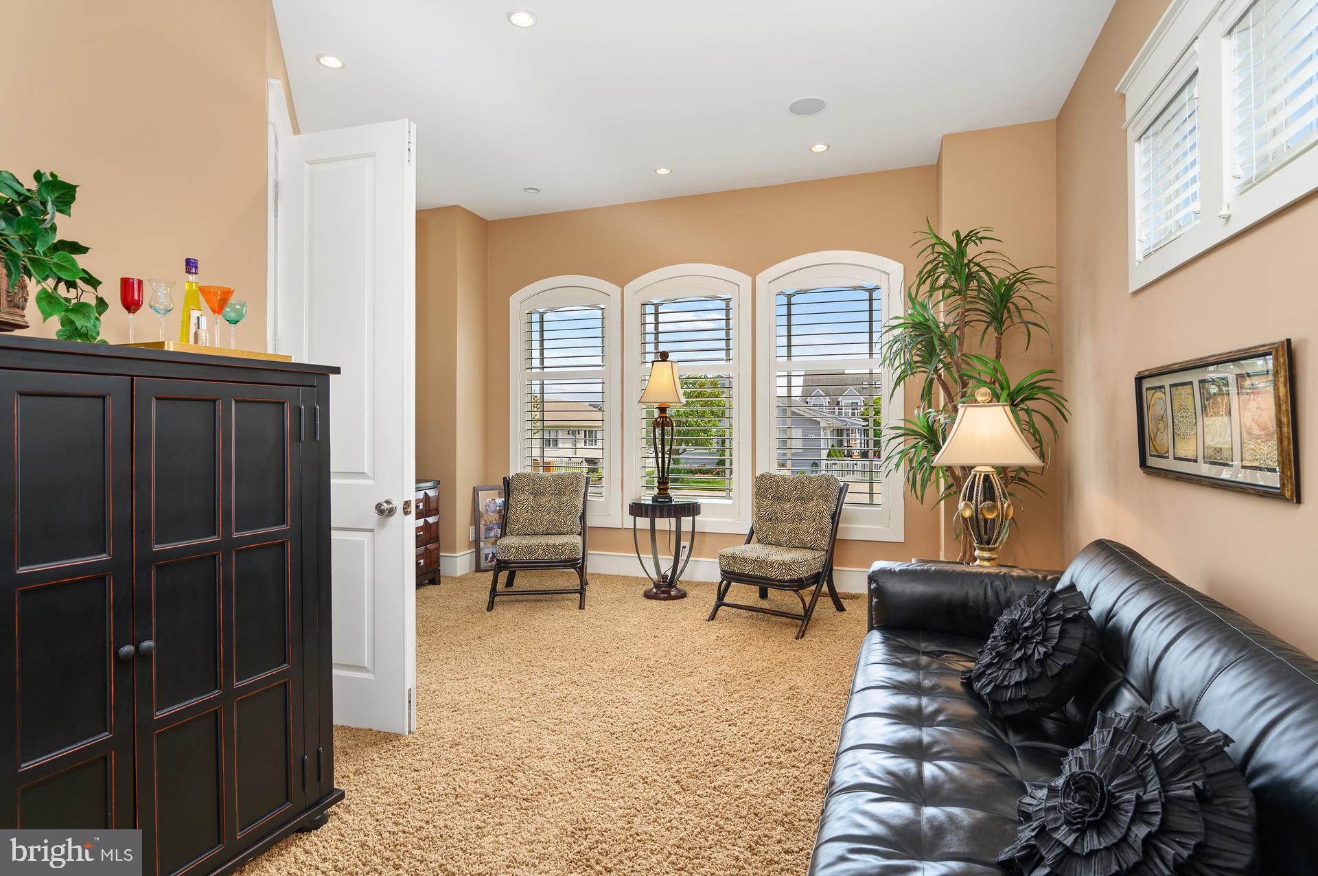 160 Channel Buoy Road Ocean City, MD 21842 - Photo 20 of 71 a living room with furniture and a potted plant