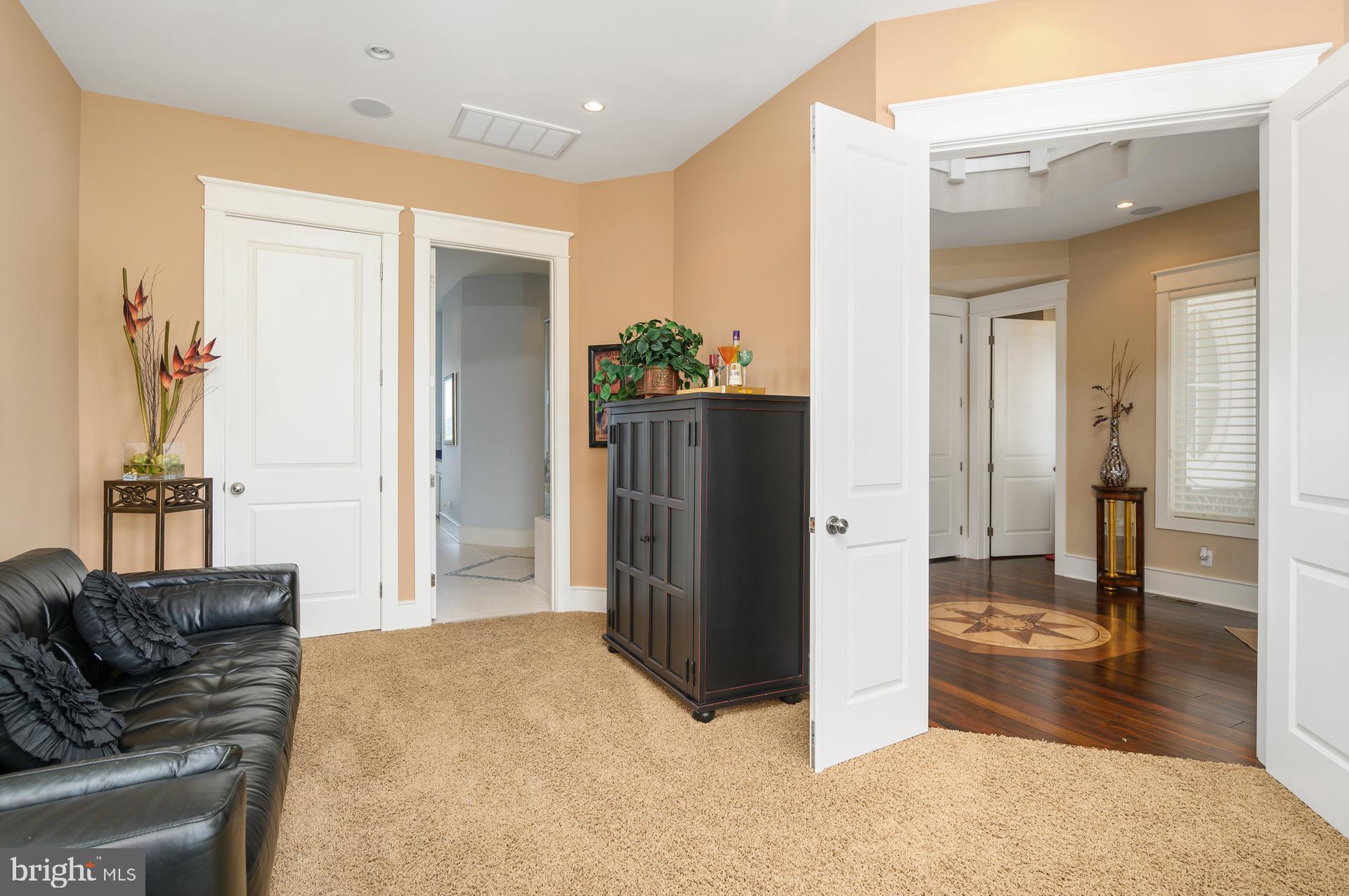 160 Channel Buoy Road Ocean City, MD 21842 - Photo 21 of 71 a living room with furniture and a dining table