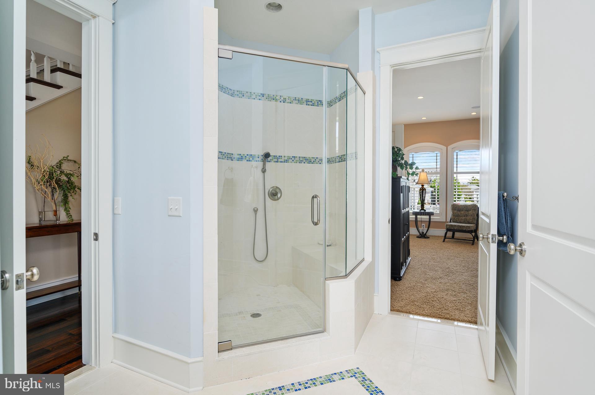 160 Channel Buoy Road Ocean City, MD 21842 - Photo 22 of 71 a bathroom with a glass shower door and a glass door