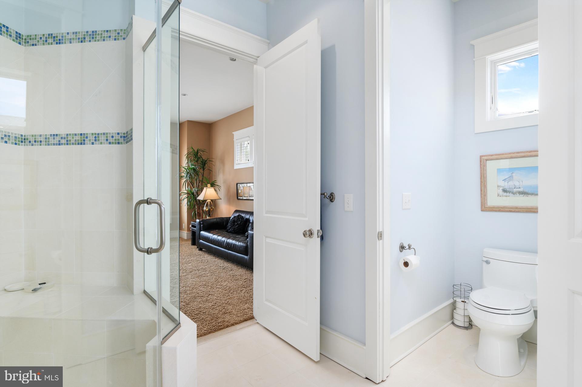 160 Channel Buoy Road Ocean City, MD 21842 - Photo 23 of 71 a bathroom with a granite countertop shower and a toilet