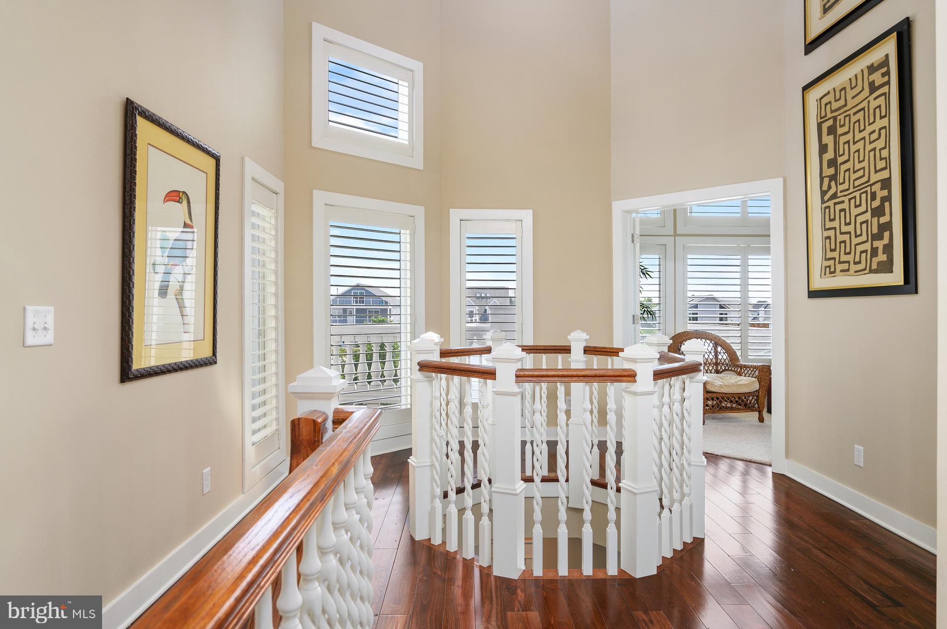160 Channel Buoy Road Ocean City, MD 21842 - Photo 26 of 71 a view of a dining room with furniture window and wooden floor