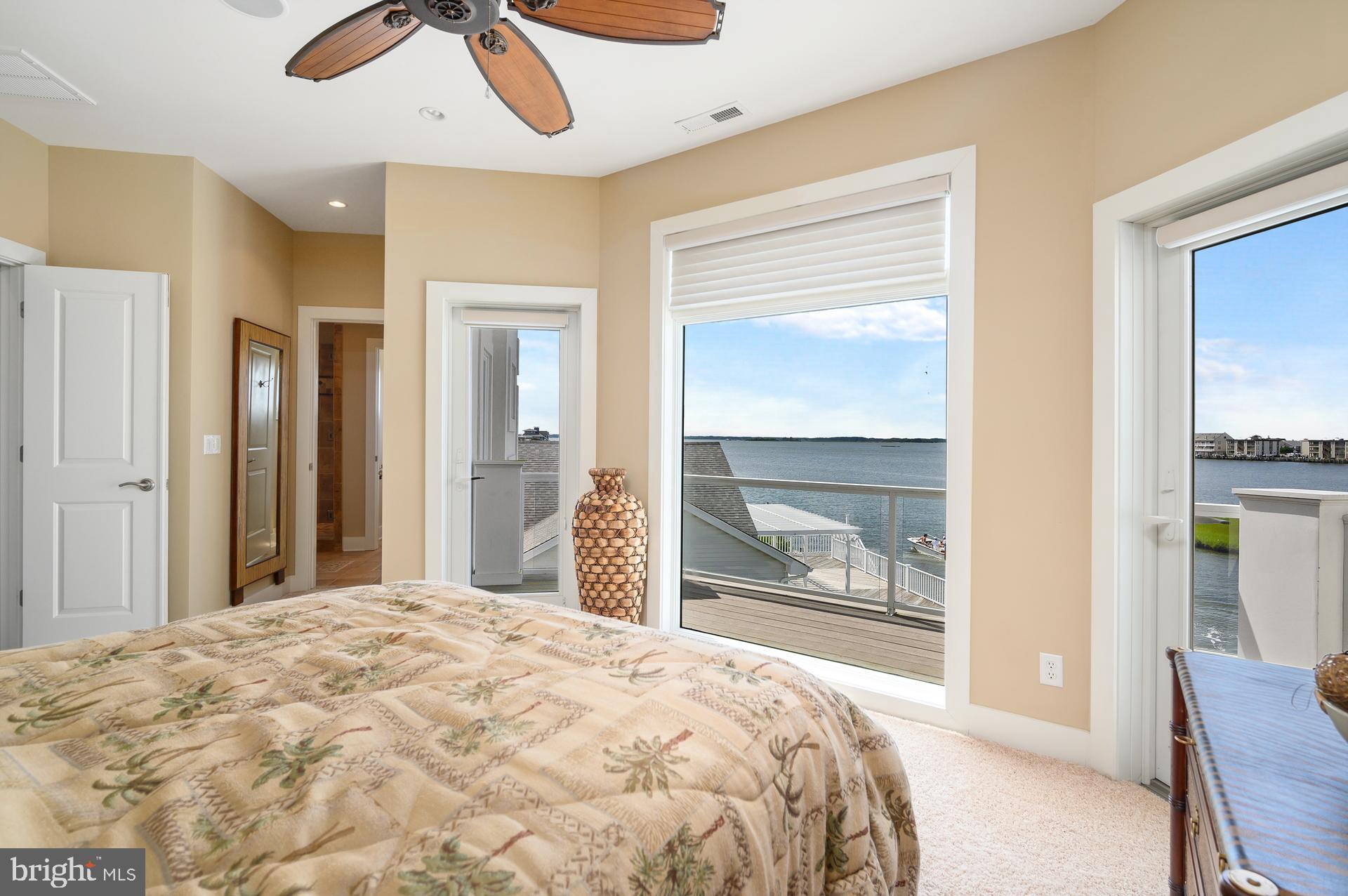 160 Channel Buoy Road Ocean City, MD 21842 - Photo 34 of 71 a bedroom with a bed and a large window with outer view