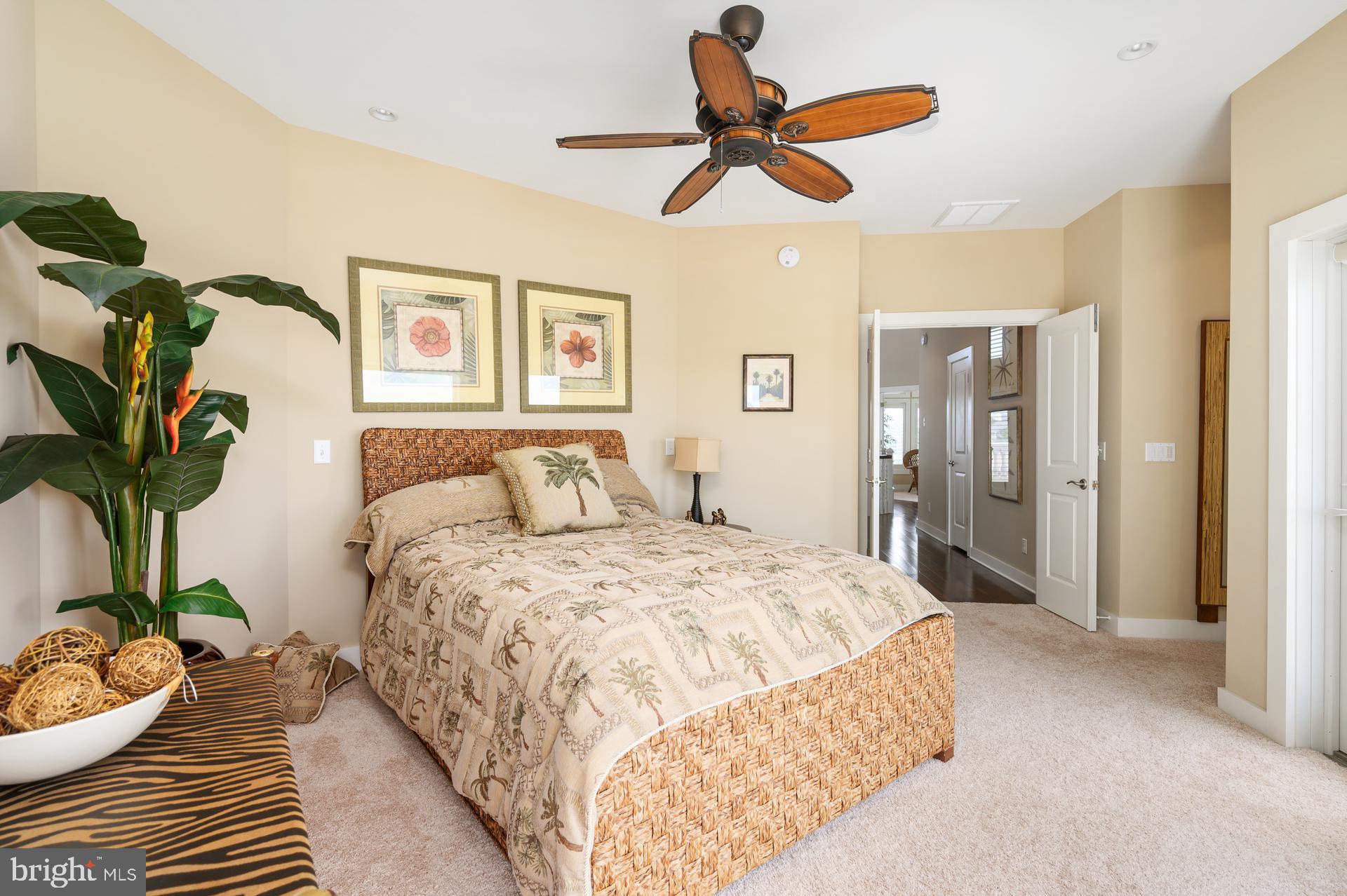 160 Channel Buoy Road Ocean City, MD 21842 - Photo 35 of 71 a spacious bedroom with a bed and a potted plant