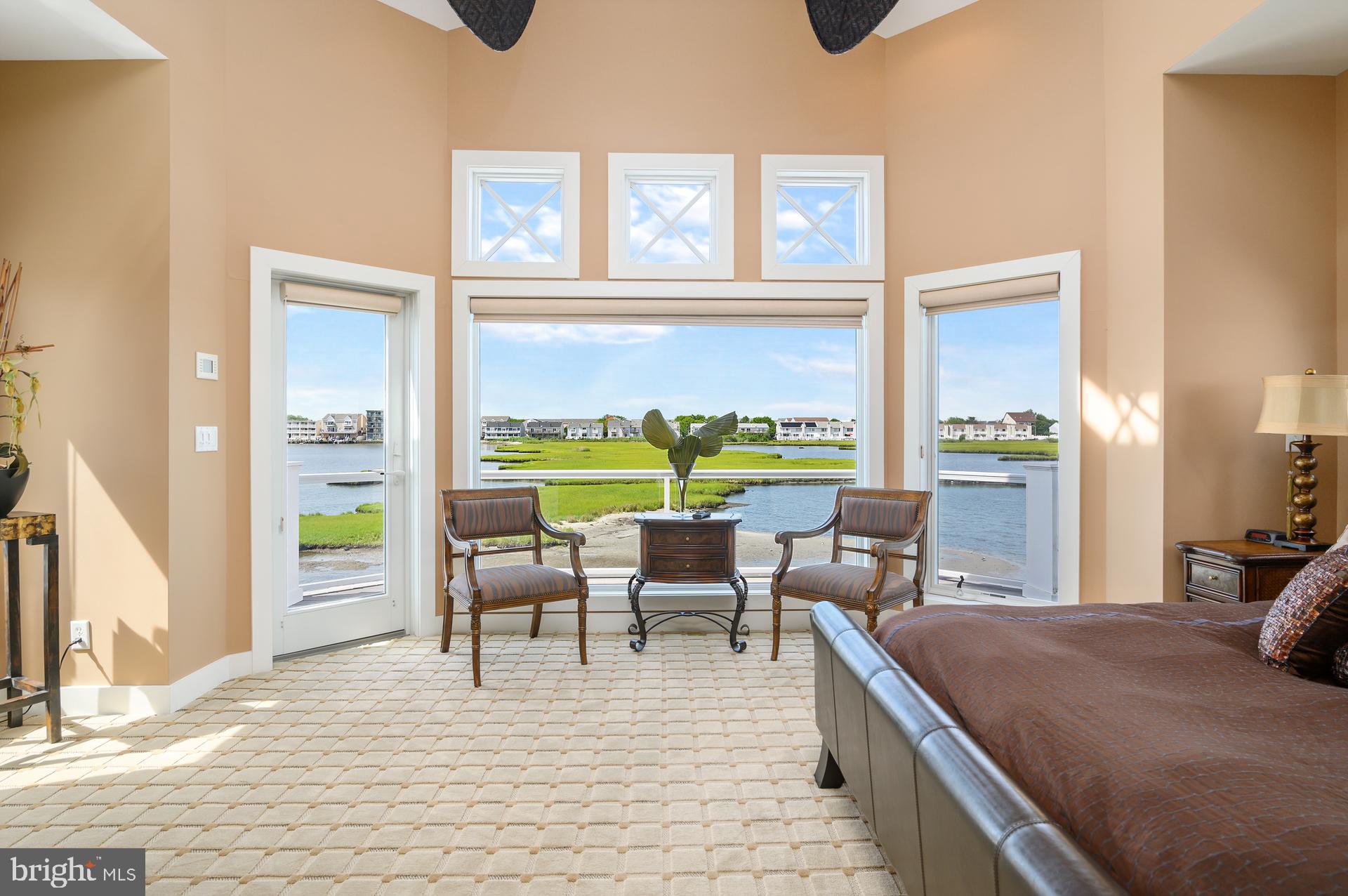 160 Channel Buoy Road Ocean City, MD 21842 - Photo 40 of 71 a living room with furniture and floor to ceiling windows