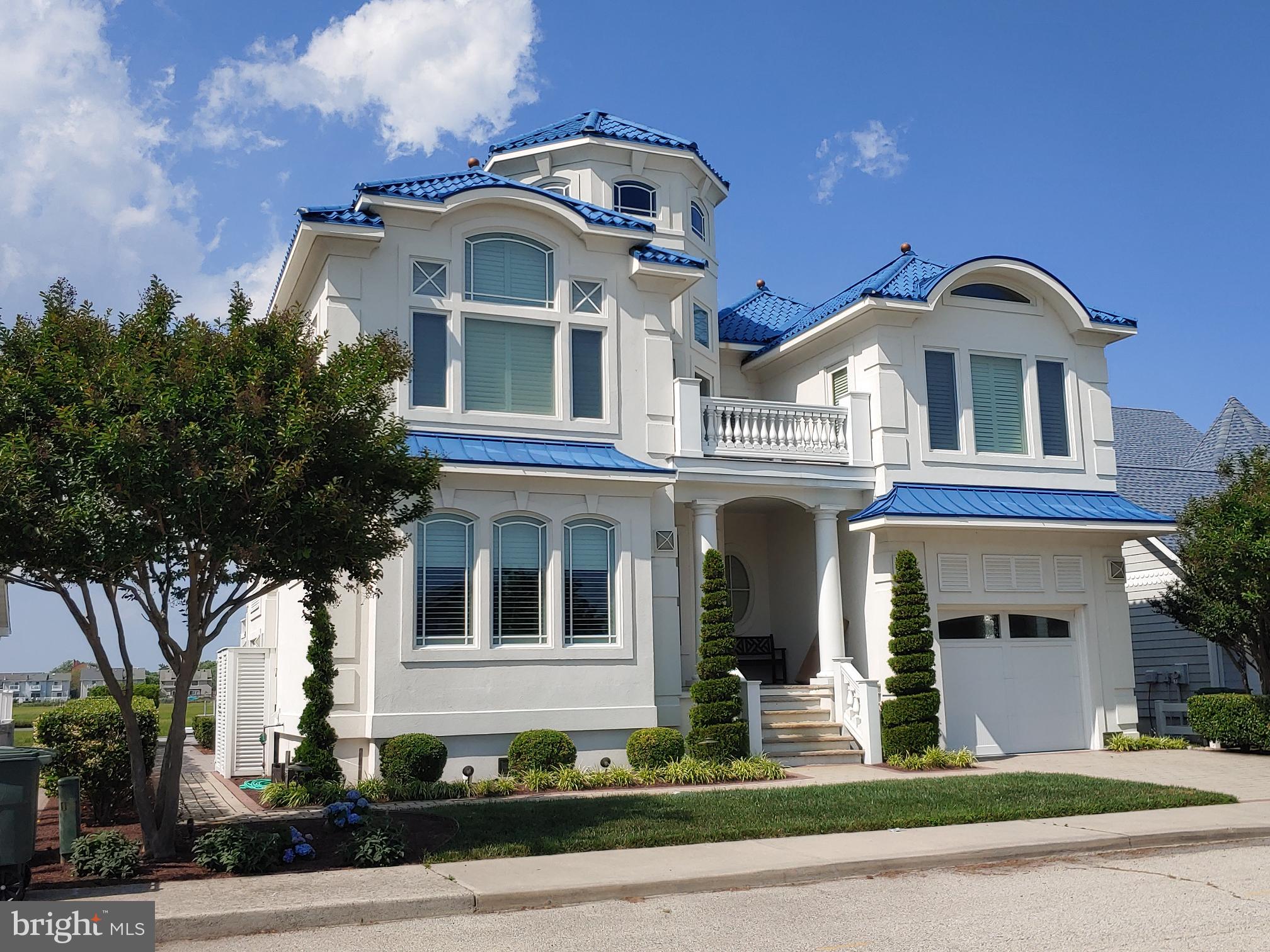 160 Channel Buoy Road Ocean City, MD 21842 - Photo 4 of 71 a front view of a house with a yard
