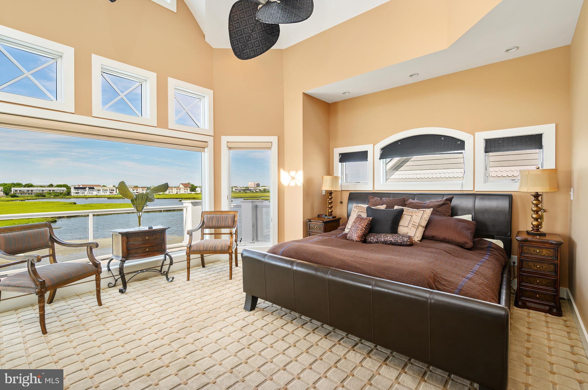 160 Channel Buoy Road Ocean City, MD 21842 - Photo 44 of 71 a bedroom with a bed lamps and chairs