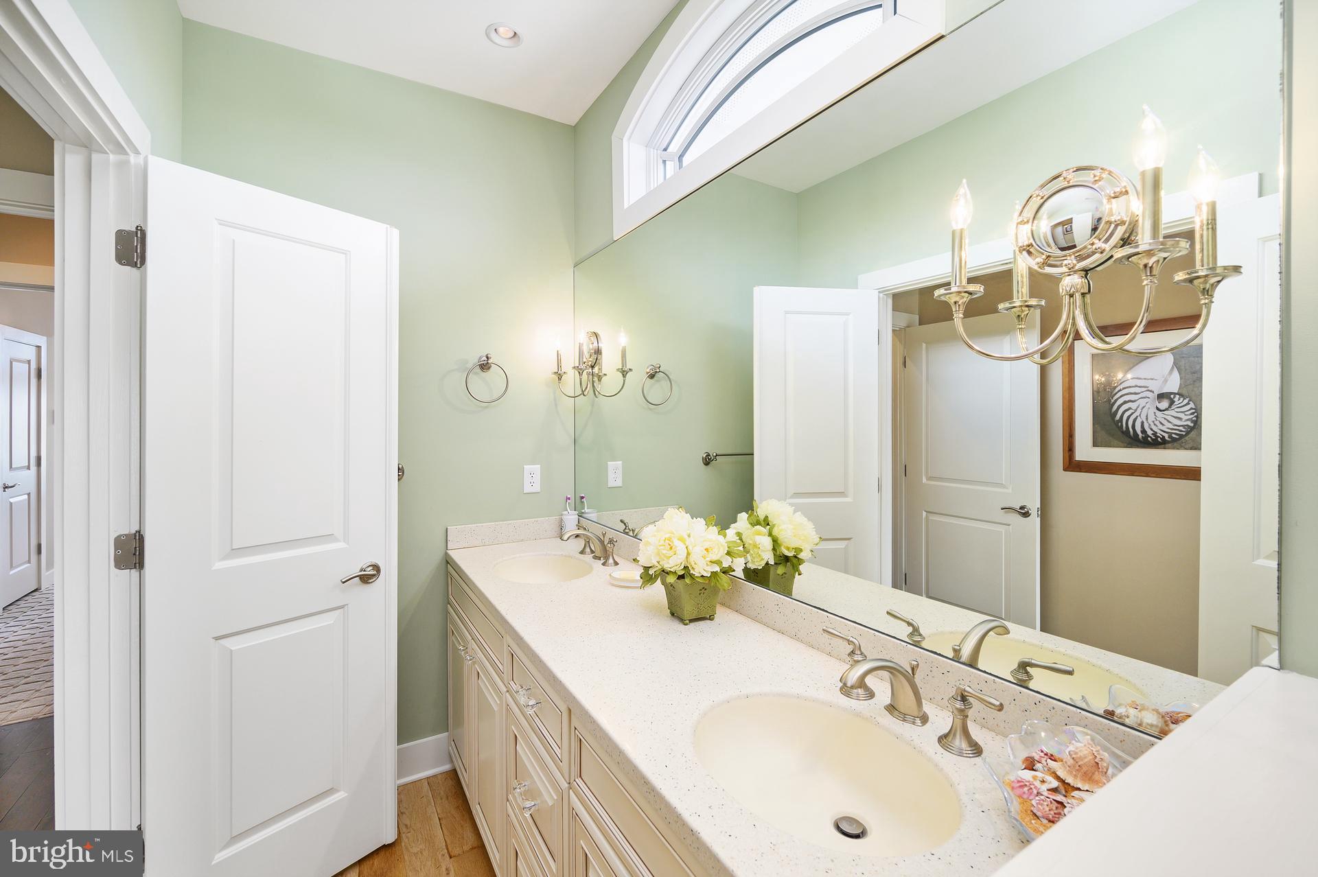 160 Channel Buoy Road Ocean City, MD 21842 - Photo 47 of 71 a bathroom with a granite countertop sink and a mirror