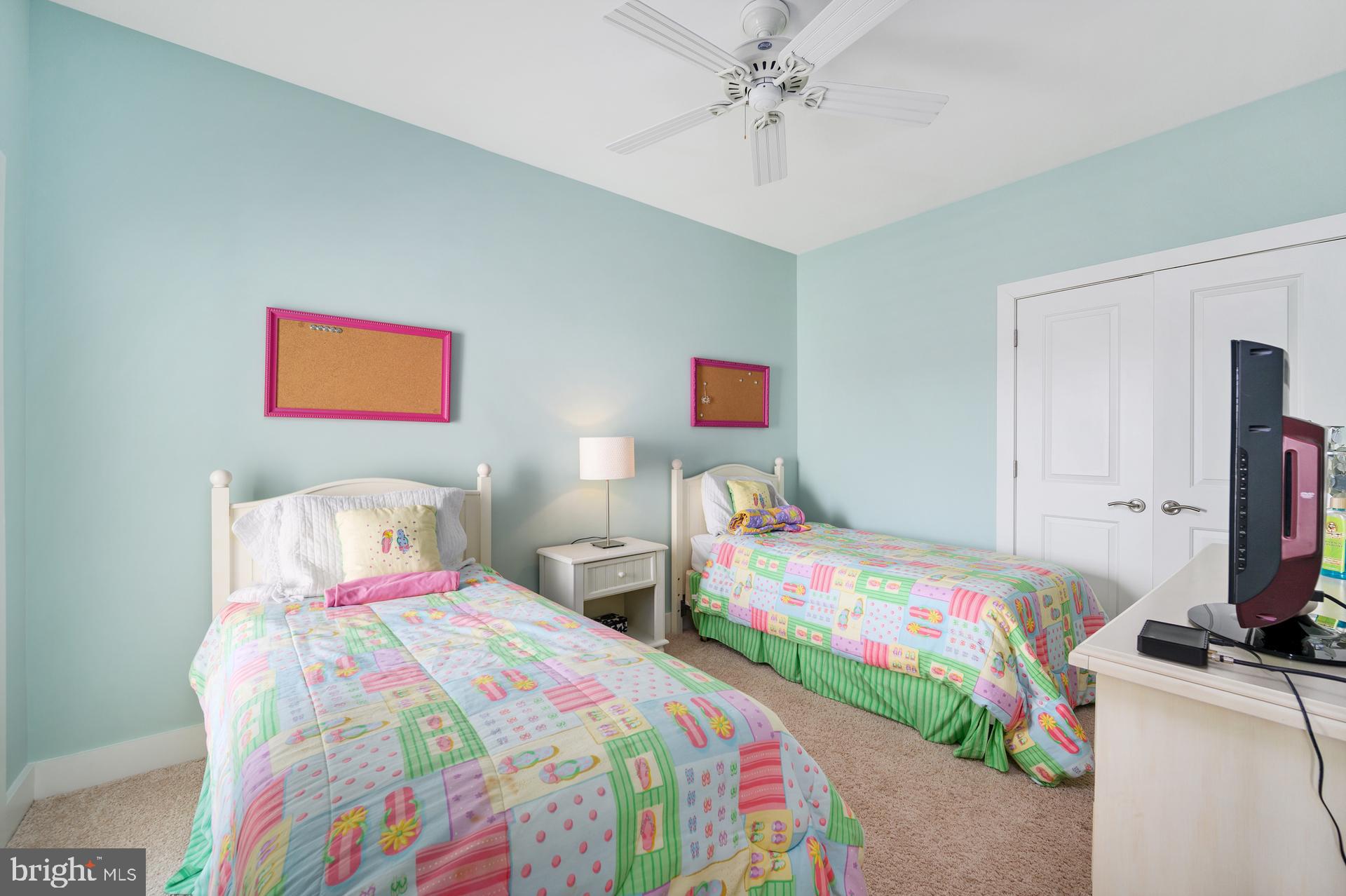 160 Channel Buoy Road Ocean City, MD 21842 - Photo 48 of 71 a bedroom with a bed and a chandelier