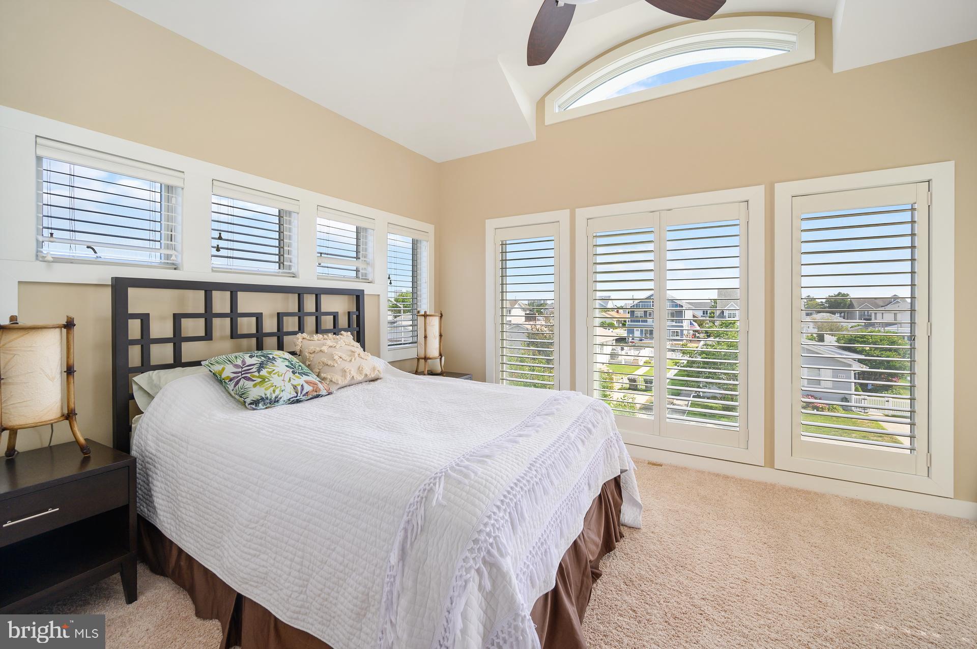 160 Channel Buoy Road Ocean City, MD 21842 - Photo 49 of 71 a bedroom with a large bed and a large window