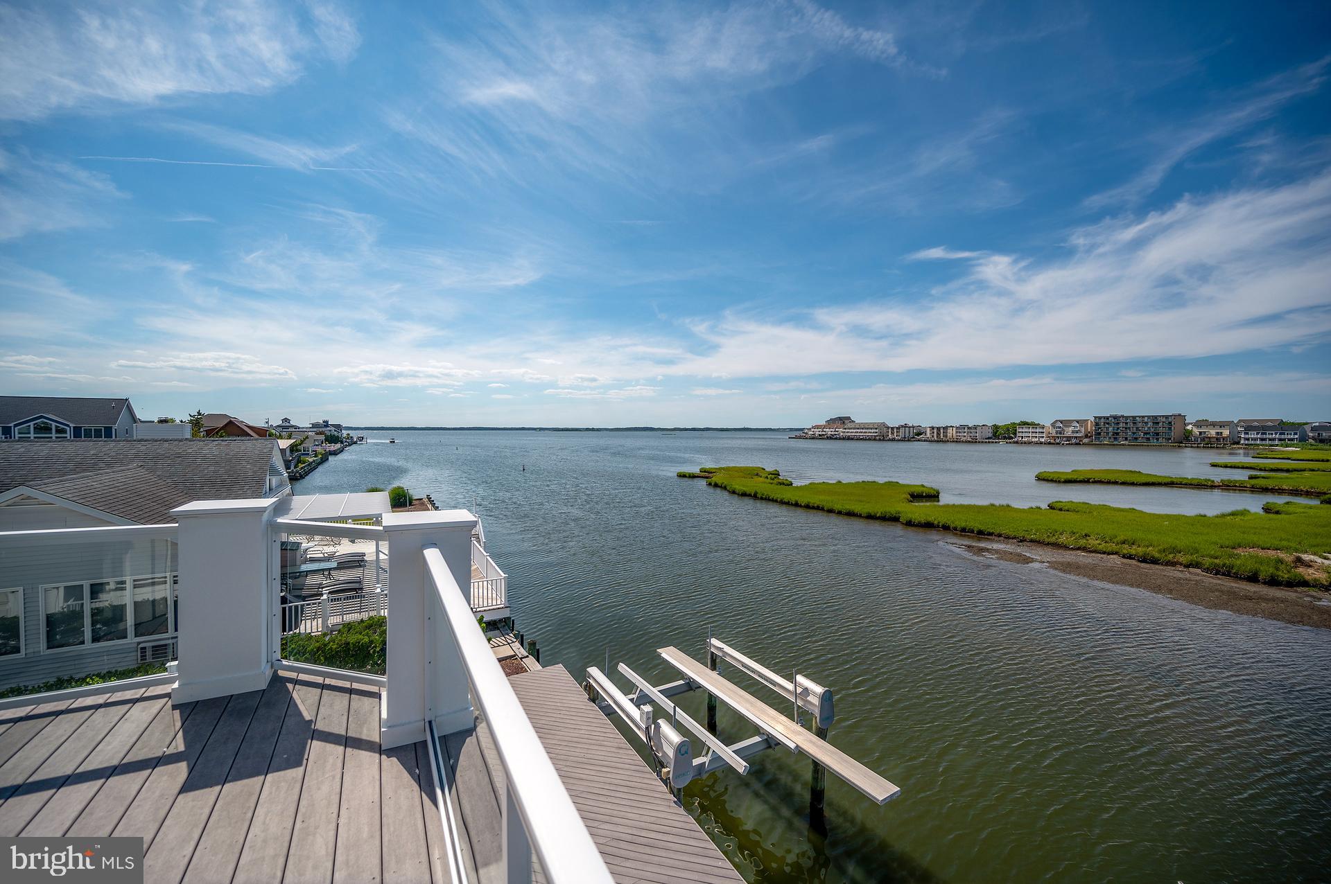 160 Channel Buoy Road Ocean City, MD 21842 - Photo 54 of 71 a view of a balcony with wooden floor and lake view