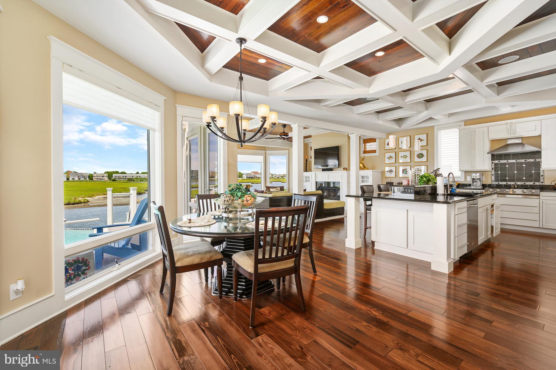 160 Channel Buoy Road Ocean City, MD 21842 - Photo 7 of 71 a view of a dining room with furniture window and wooden floor