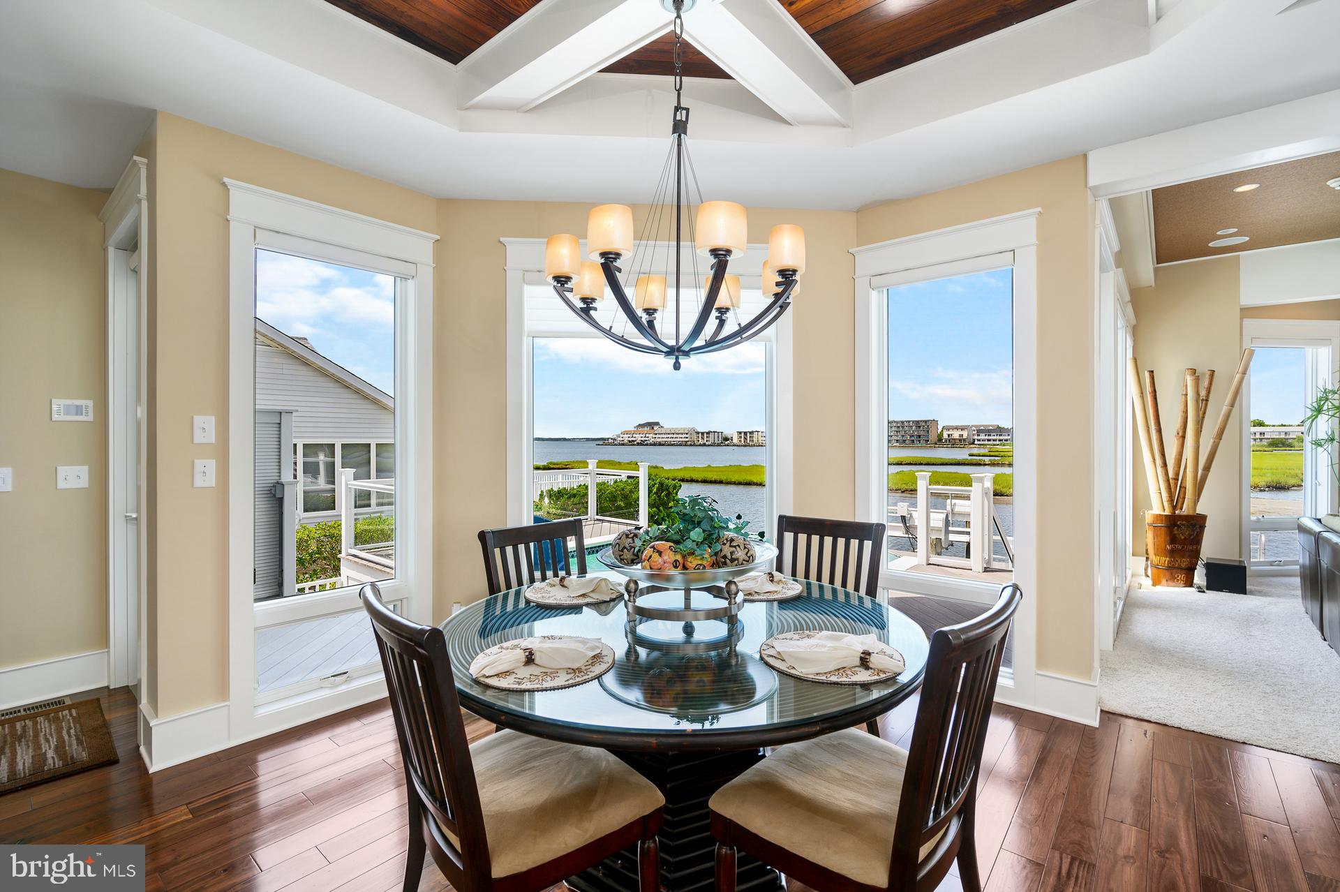 160 Channel Buoy Road Ocean City, MD 21842 - Photo 8 of 71 a view of a dining room with furniture window and wooden floor