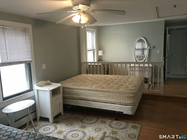 a bed sitting in a room next to a window