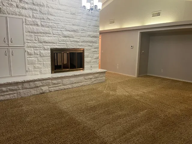 a view of empty room with a fireplace