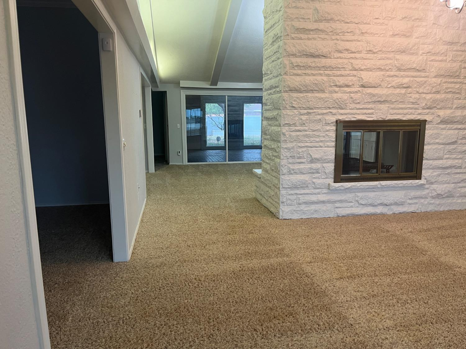 710 North 17th Street Lamesa, TX 79331 - Photo 15 of 41 a view of an empty room with a fireplace and a window