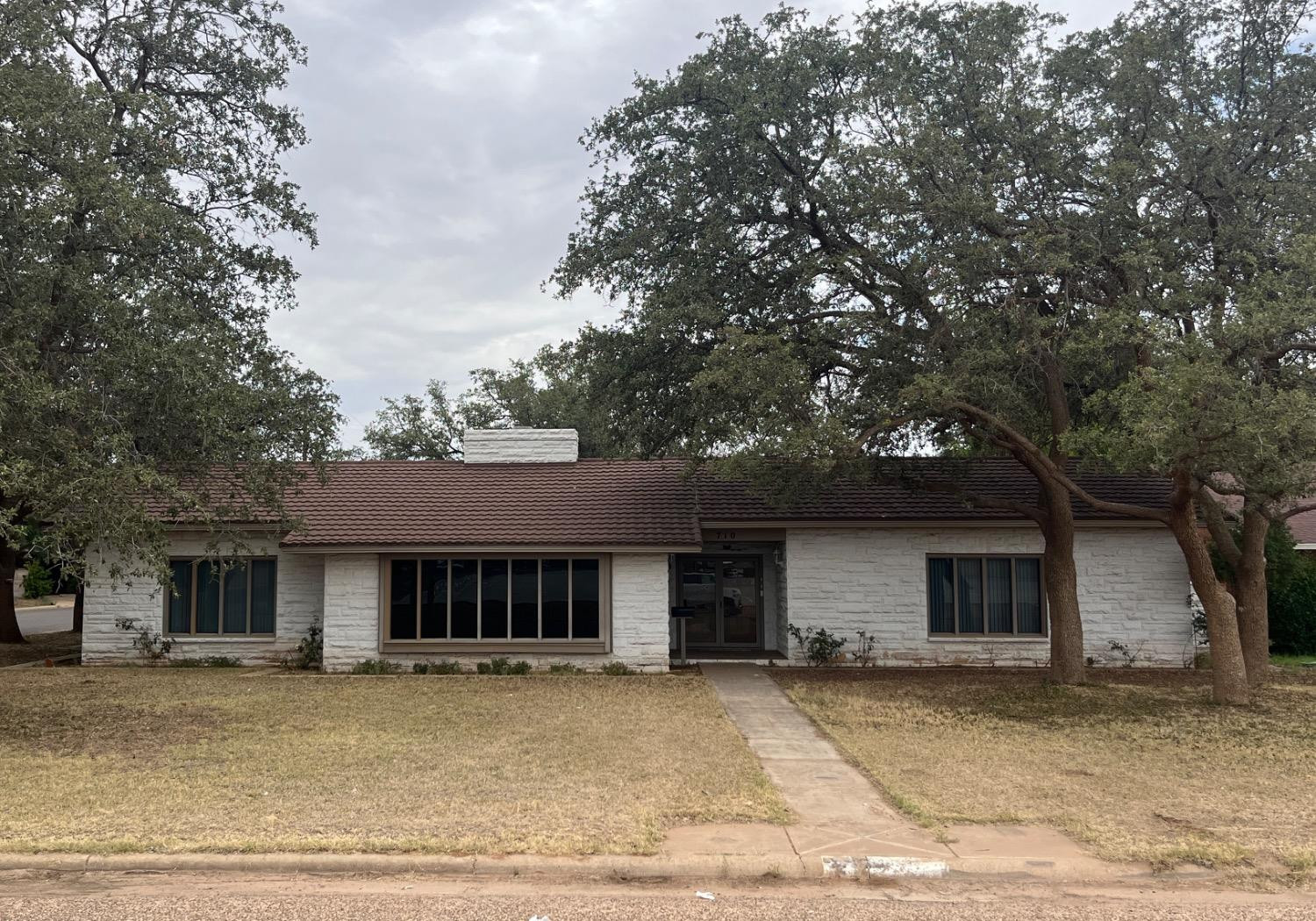 710 North 17th Street Lamesa, TX 79331 - Photo 2 of 41 a front view of a house with a yard and garage