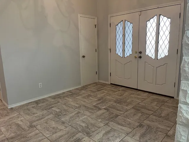 a view of a bathroom with wooden floor and windows