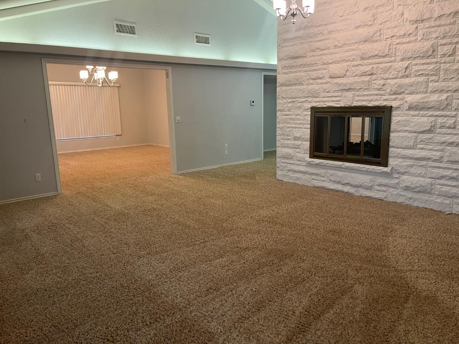 710 North 17th Street Lamesa, TX 79331 - Photo 7 of 41 a view of empty room with window and fireplace